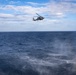 An MH-60R Seahawk helicopter conducts maritime interception maneuvers