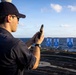 U.S. Sailor reloads an M18 pistol on the flight deck during a live-fire exercise
