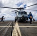 U.S. Sailors prepare to chock and chain an MH-60R Seahawk helicopter