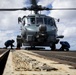 U.S. Sailors chock and chain an MH-60R Seahawk helicopter on the flight deck
