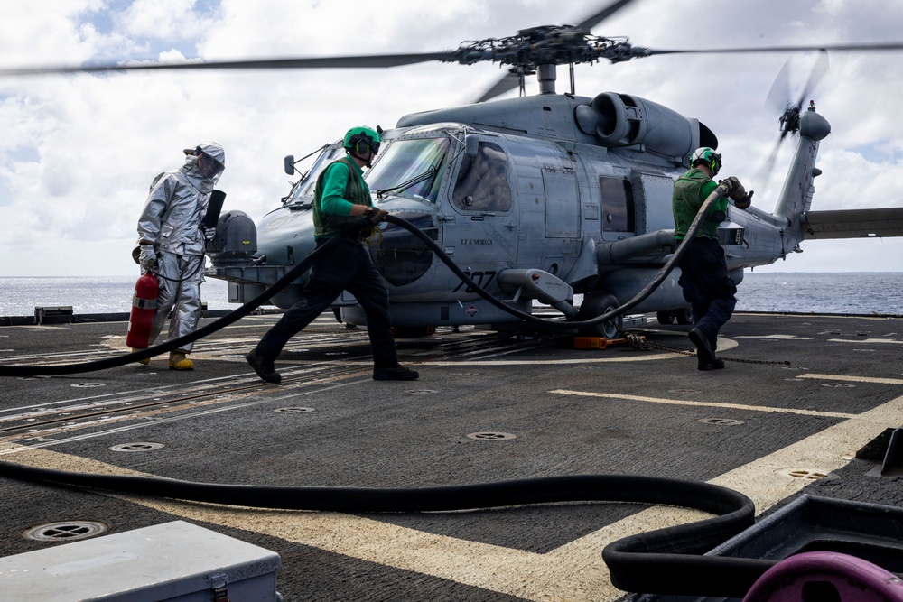 U.S. Sailors prepare to refuel an MH-60R Seahawk helicopter