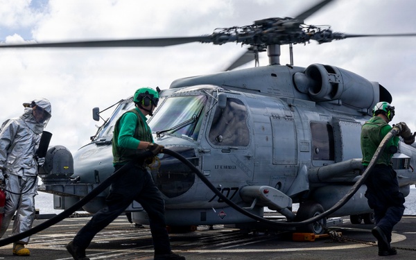 U.S. Sailors prepare to refuel an MH-60R Seahawk helicopter