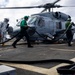 U.S. Sailors prepare to refuel an MH-60R Seahawk helicopter