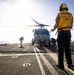 U.S. Sailors, assigned to the Iwo Jima Amphibious Ready Group, chock and chain an MH-60R