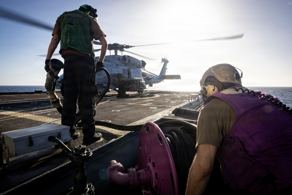 U.S. Sailors, assigned to the Iwo Jima Amphibious Ready Group, reel in a fuel line