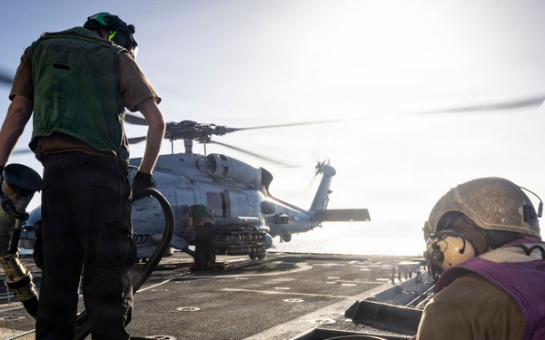 U.S. Sailors, assigned to the Iwo Jima Amphibious Ready Group, reel in a fuel line
