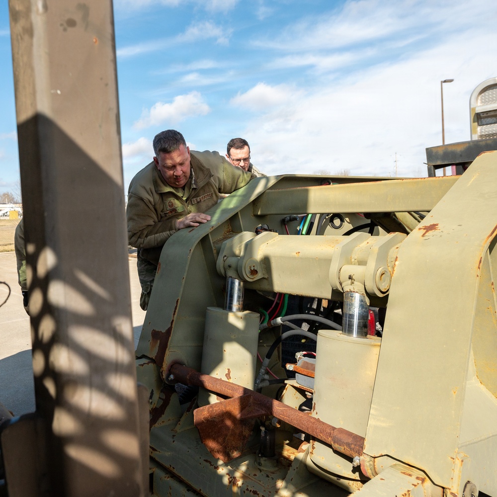 Airmen load an old and disabled snowblower