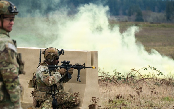 U.S. Soldiers execute team maneuvers during live fire training