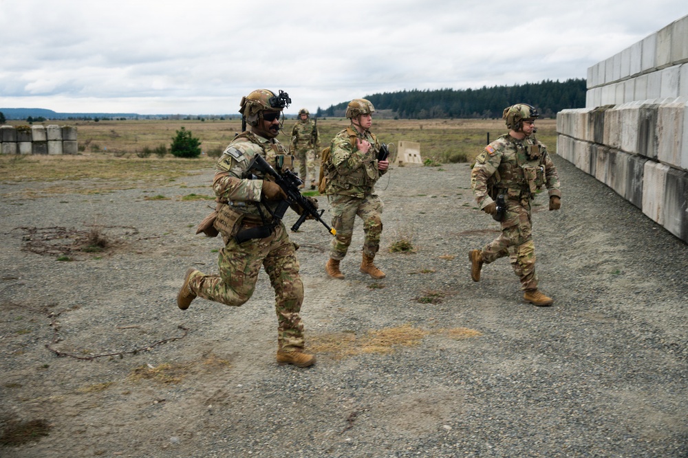 U.S. Soldiers execute team maneuvers during live fire training