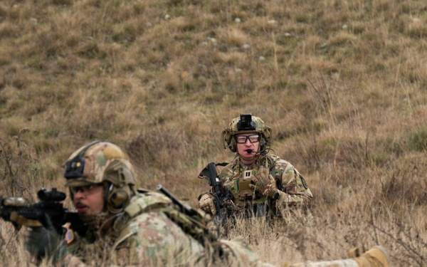 U.S. Soldiers execute team maneuvers during live fire training