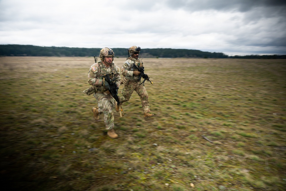 U.S. Soldiers execute team maneuvers during live fire training