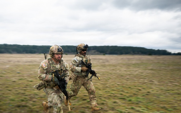 U.S. Soldiers execute team maneuvers during live fire training