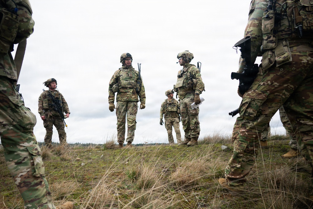 U.S. Soldiers execute team maneuvers during live fire training