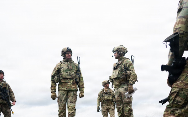 U.S. Soldiers execute team maneuvers during live fire training