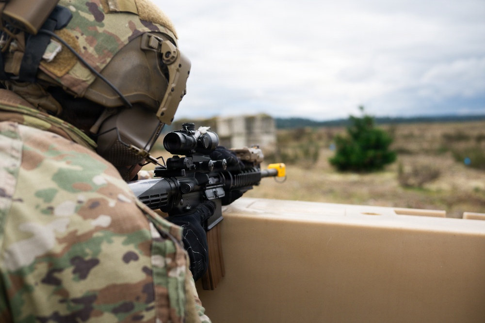 U.S. Soldiers execute team maneuvers during live fire training