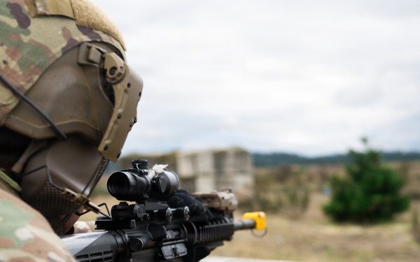 U.S. Soldiers execute team maneuvers during live fire training