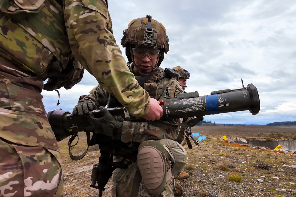 U.S. Soldiers execute team maneuvers during live fire training