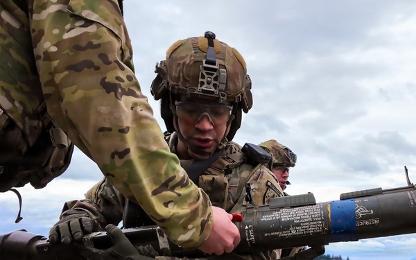 U.S. Soldiers execute team maneuvers during live fire training