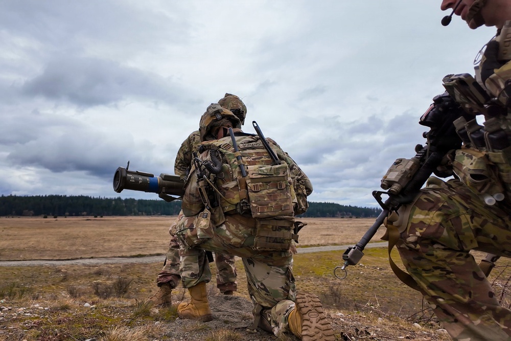 U.S. Soldiers execute team maneuvers during live fire training
