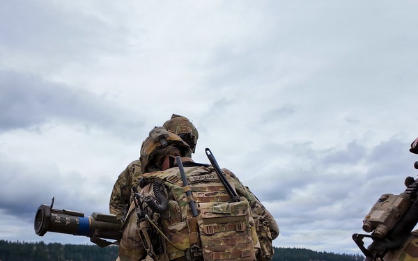 U.S. Soldiers execute team maneuvers during live fire training