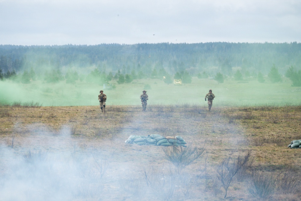 U.S. Soldiers execute team maneuvers during live fire training