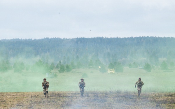 U.S. Soldiers execute team maneuvers during live fire training