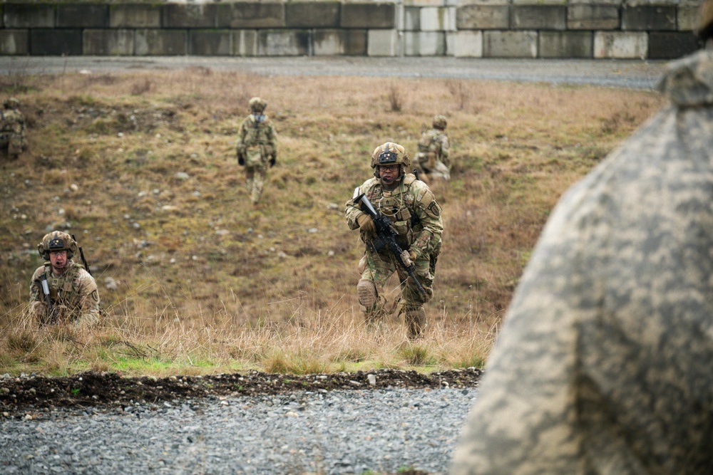 U.S. Soldiers execute team maneuvers during live fire training