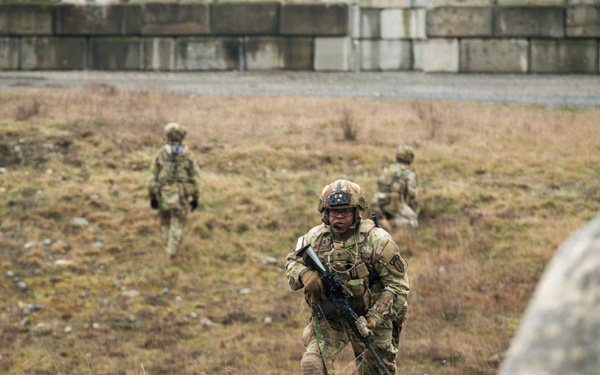 U.S. Soldiers execute team maneuvers during live fire training