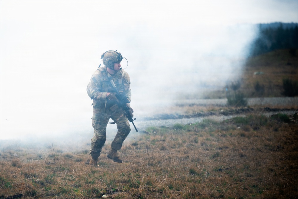 U.S. Soldiers execute team maneuvers during live fire training