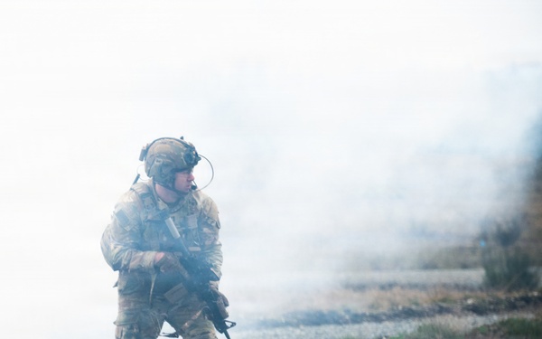 U.S. Soldiers execute team maneuvers during live fire training