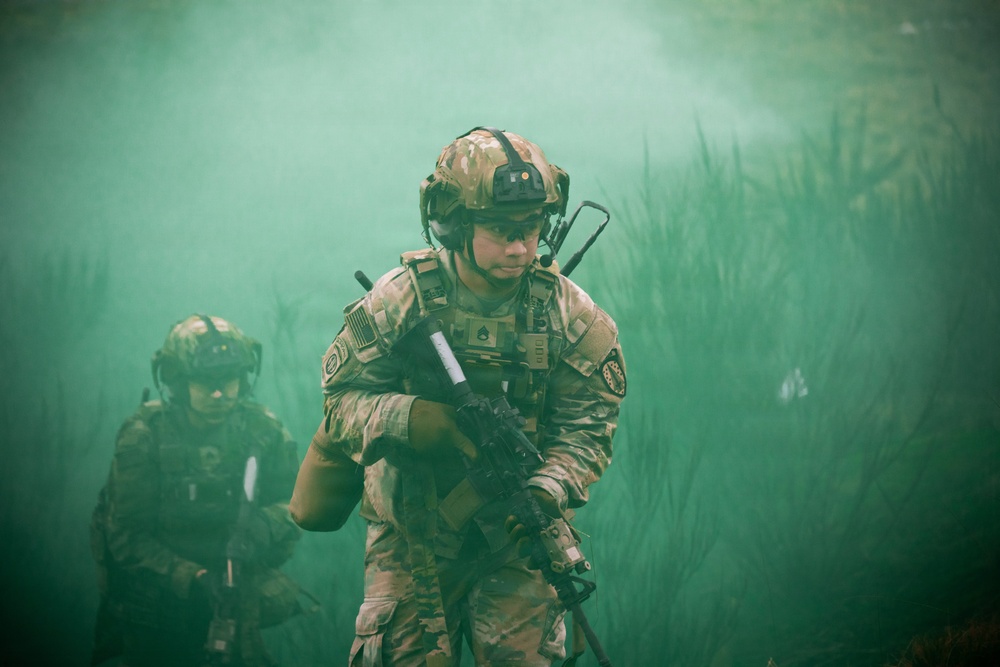 U.S. Soldiers execute team maneuvers during live fire training