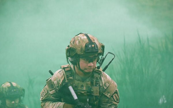 U.S. Soldiers execute team maneuvers during live fire training