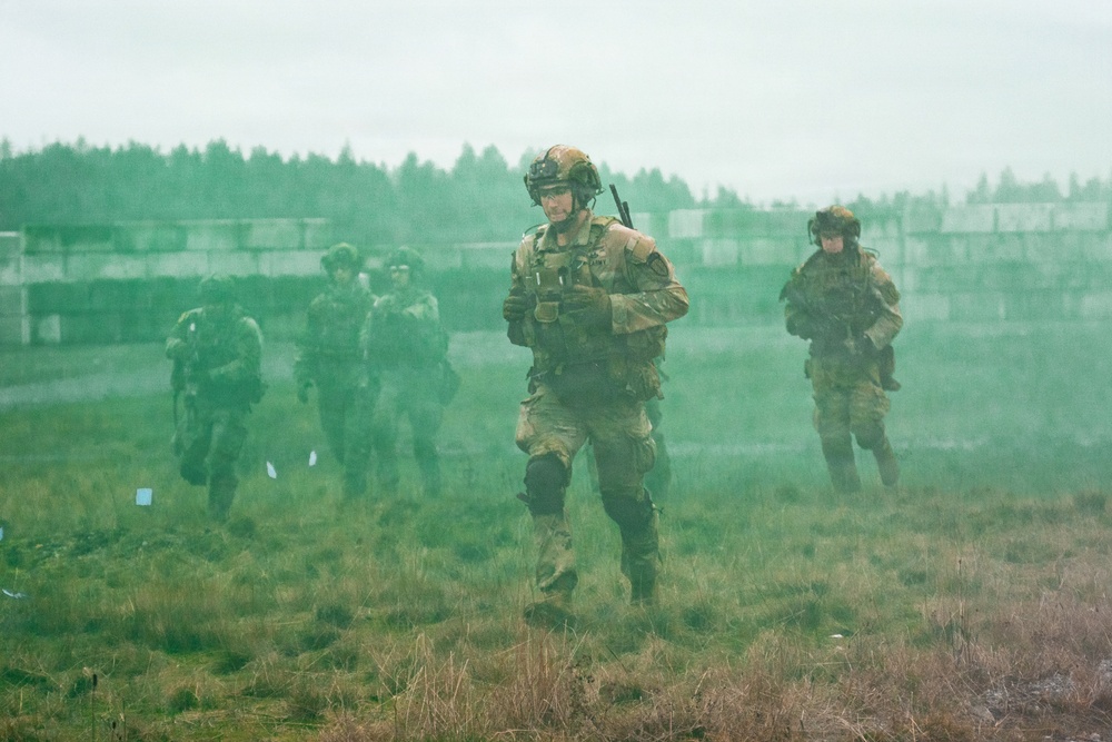 U.S. Soldiers execute team maneuvers during live fire training