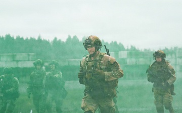 U.S. Soldiers execute team maneuvers during live fire training
