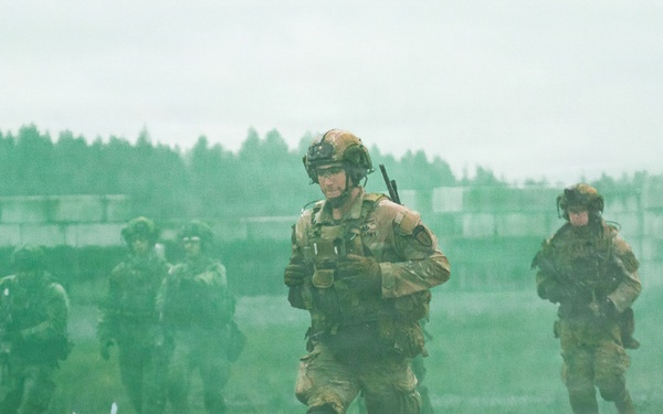 U.S. Soldiers execute team maneuvers during live fire training