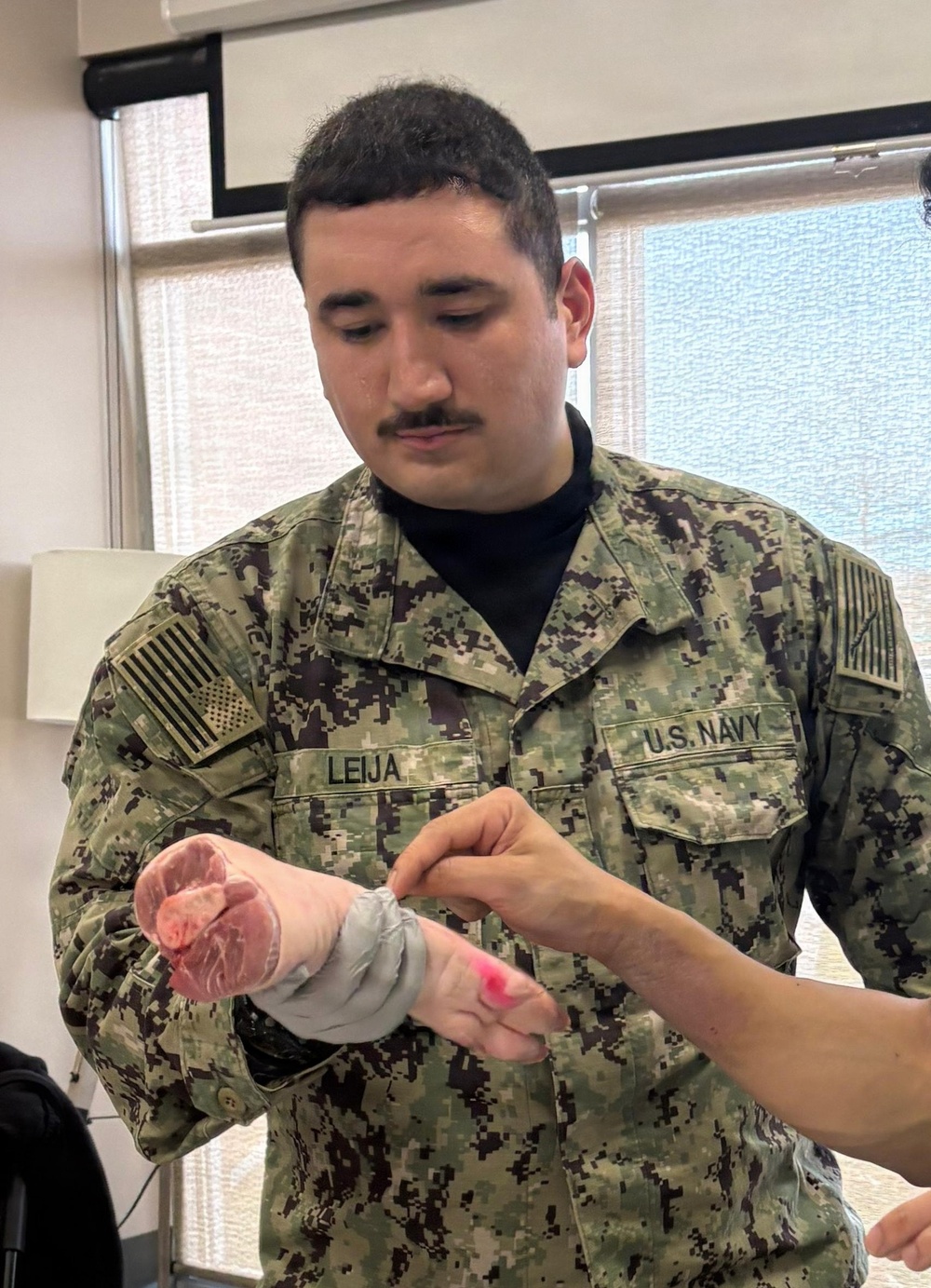 Corpsman Inspects Suture Work During Training