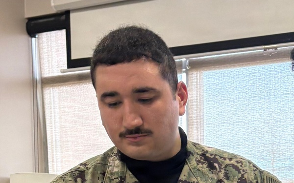 Corpsman Inspects Suture Work During Training