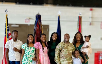 Major Sorffly Dvius poses with his family following a ceremony.