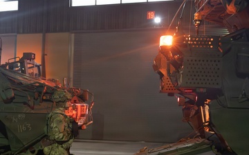 Soldier stands beside a M1126 Stryker