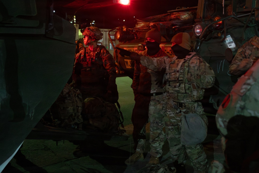 Soldiers load their rucks into M1126 Stryker