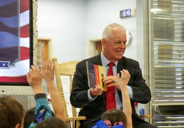 Under Secretary Anthony J. Tata Reads "Lil’ Marine" to Excited First-Graders at DoWEA Americas Crossroads Elementary School