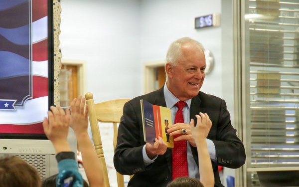 Under Secretary Anthony J. Tata Reads "Lil’ Marine" to Excited First-Graders at DoWEA Americas Crossroads Elementary School