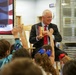 Under Secretary Anthony J. Tata Reads "Lil’ Marine" to Excited First-Graders at DoWEA Americas Crossroads Elementary School