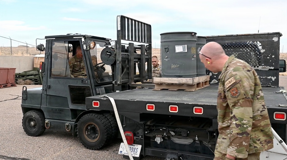 377th Maintenance Squadron Airmen load brass casings onto tractor