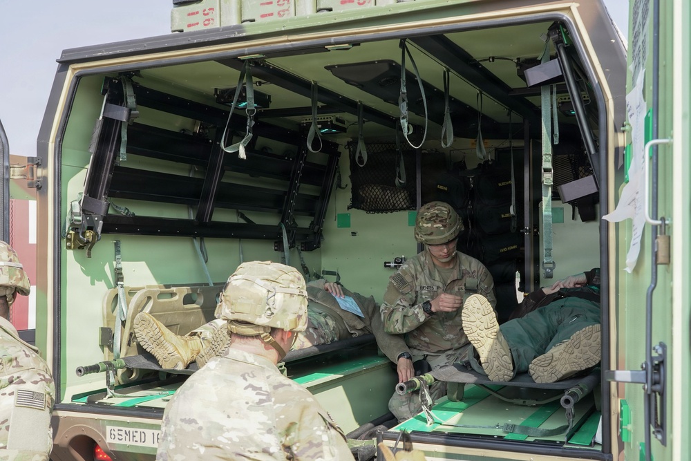 Medical teams secure patients for evacuation transport