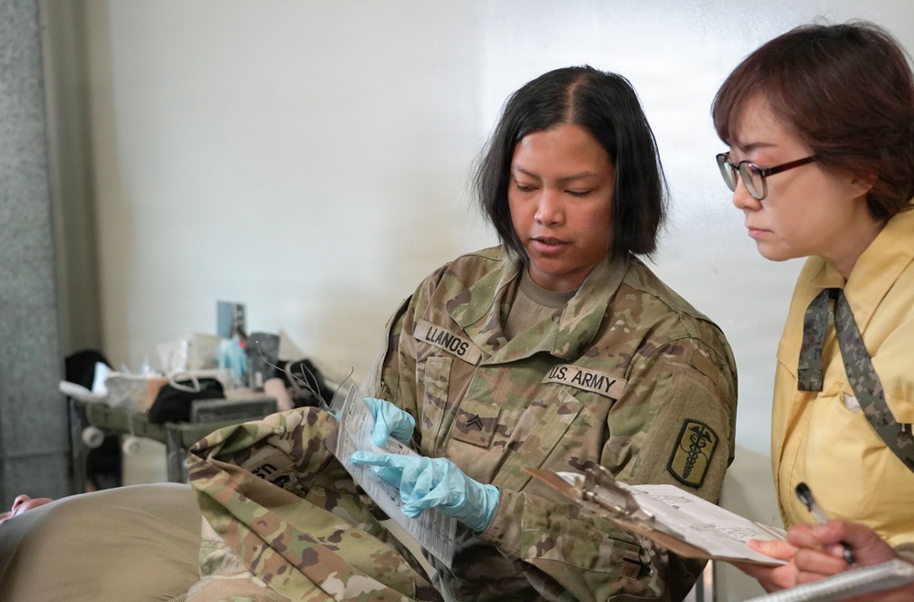Medics review patient information during exercise