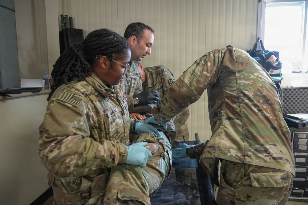 Medical personnel treat simulated casualty