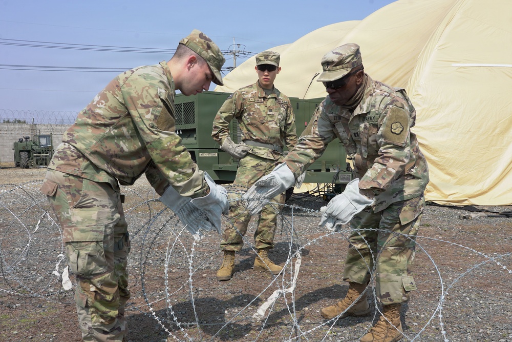 Soldiers construct defensive barrier during logistics training