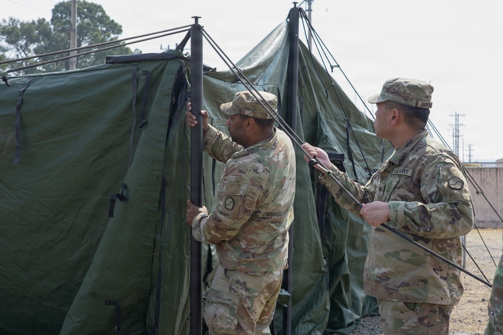 Soldiers assemble command tents during logistics exercise