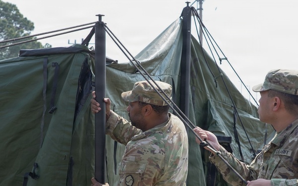 Soldiers assemble command tents during logistics exercise